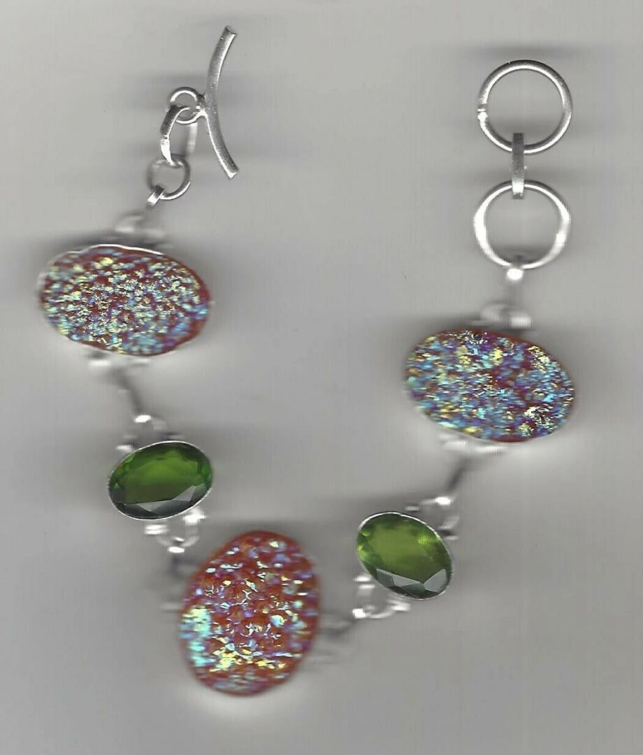 A necklace with green and red beads on it.