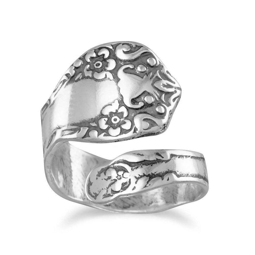 A silver spoon ring with flowers on it.