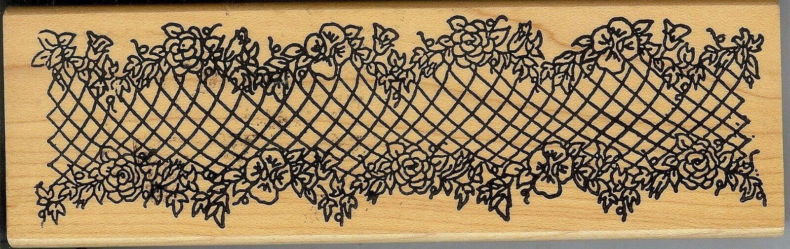 A wooden stamp with a floral design on it.