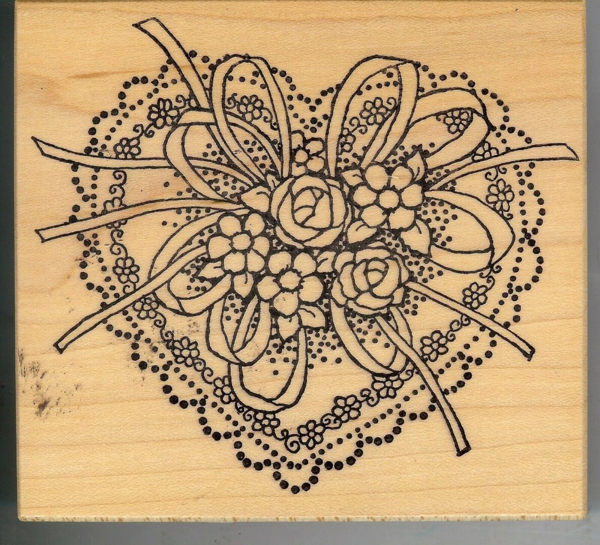 A heart with flowers and swirls on it.