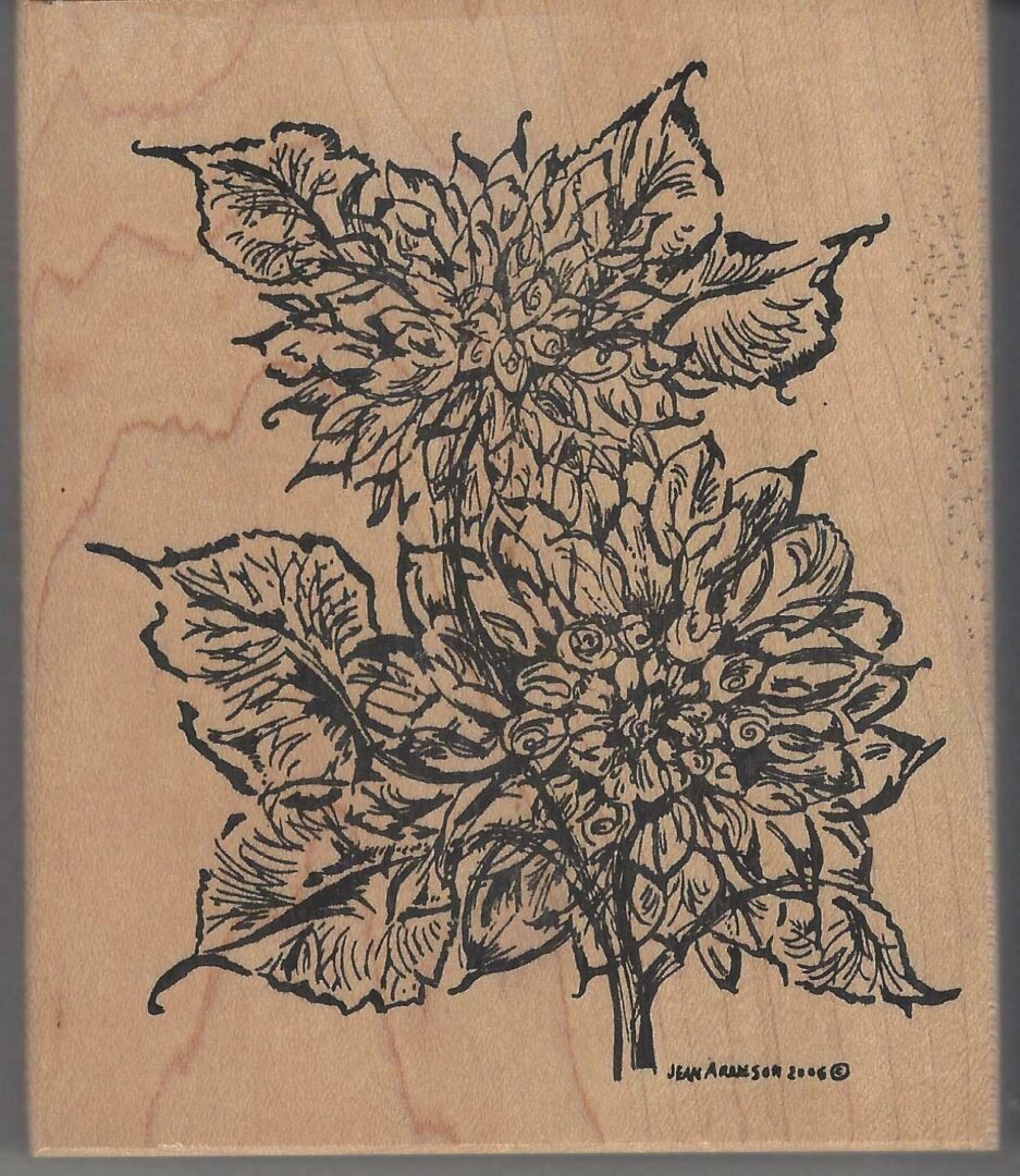 A wooden stamp with two flowers on it.