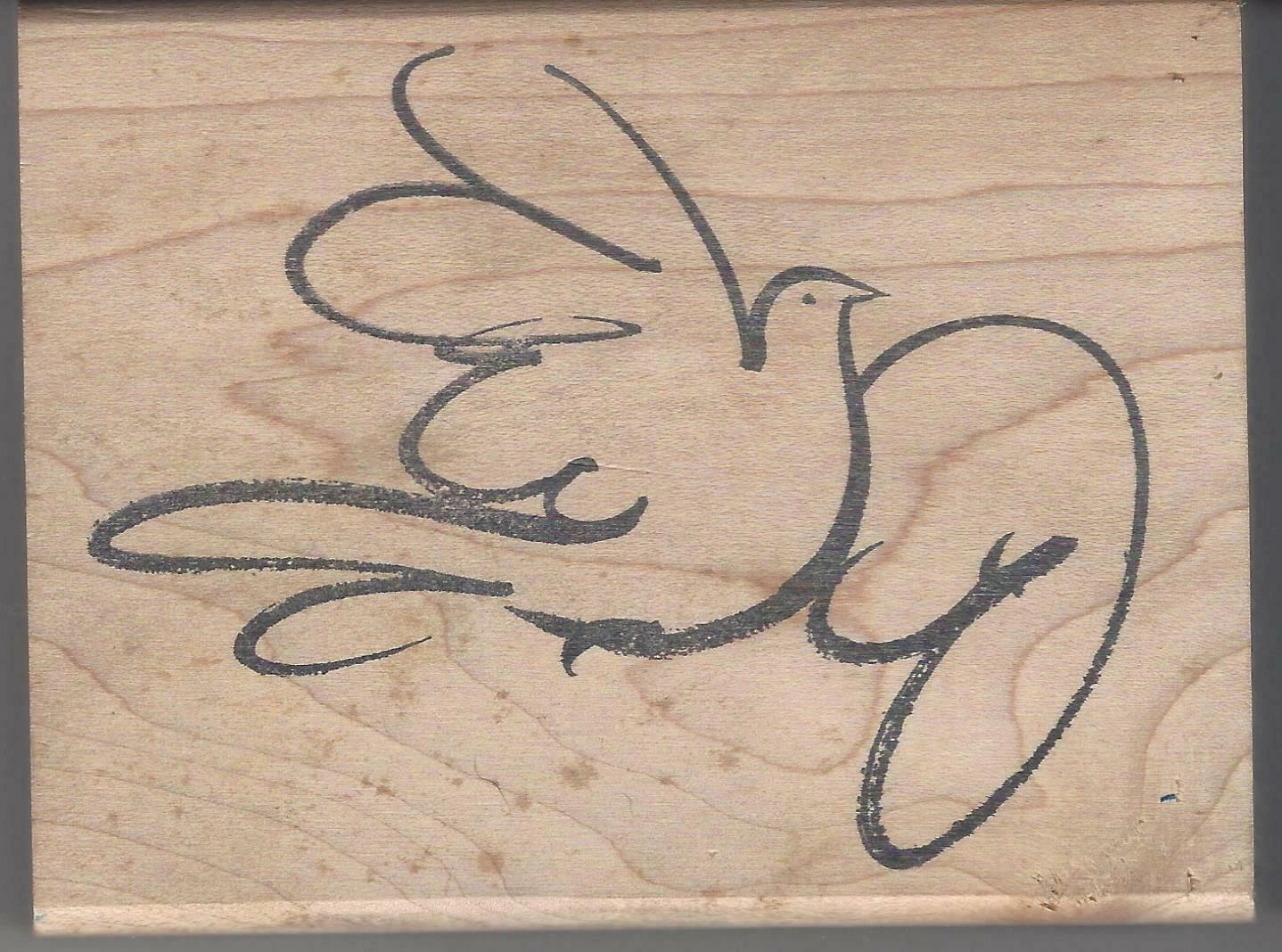 A wooden plaque with a bird drawn on it.