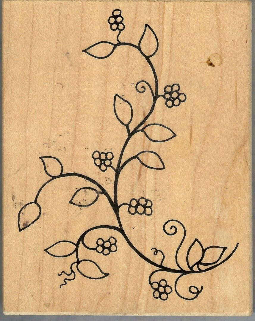 A wooden picture of a vine with flowers.
