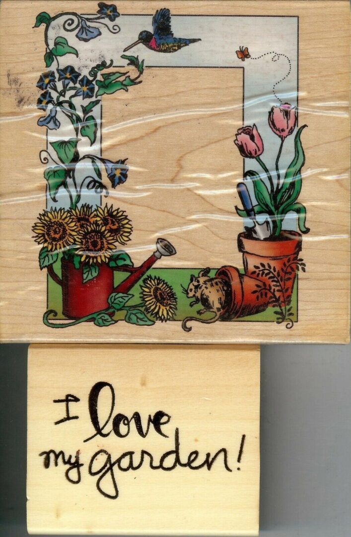 A wooden block with flowers and a watering can.