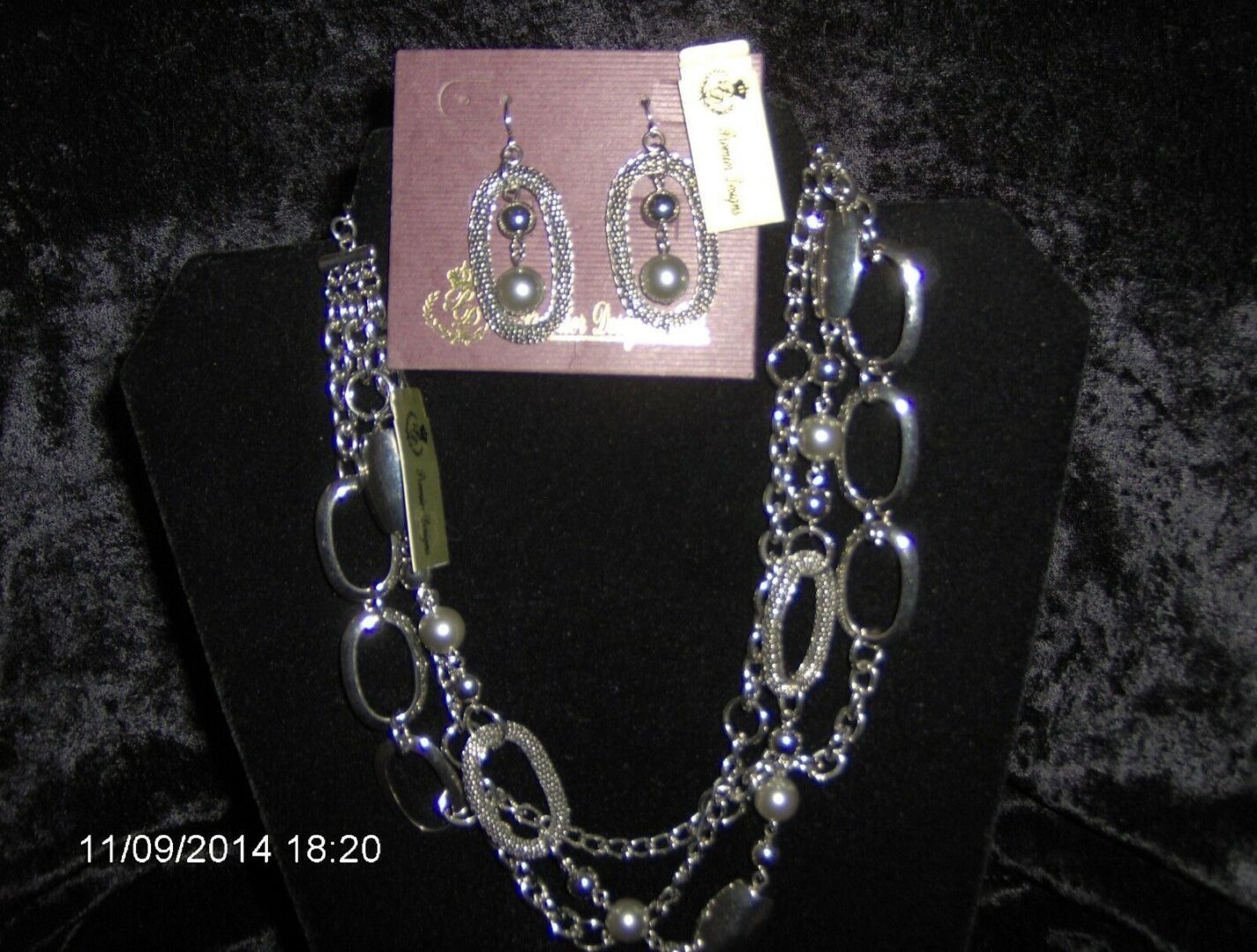 A necklace and earrings set on display.