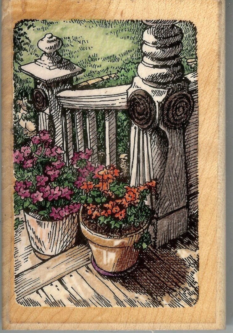 A wooden deck with flowers in pots and a fire hydrant.