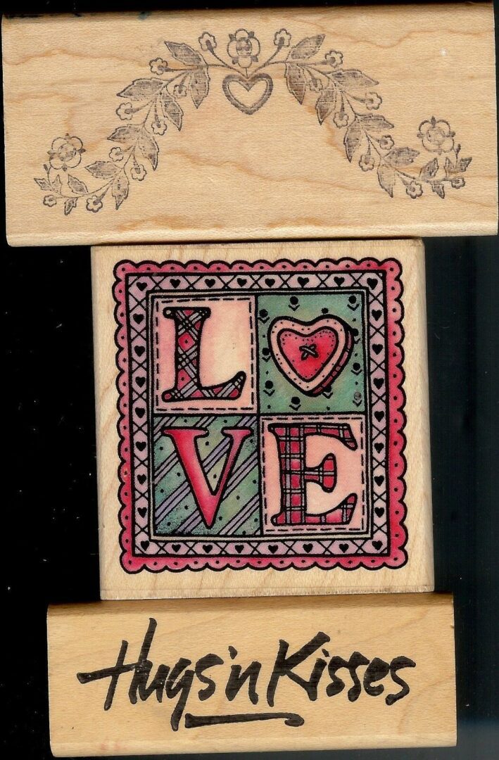 A wooden block with the word love in it.