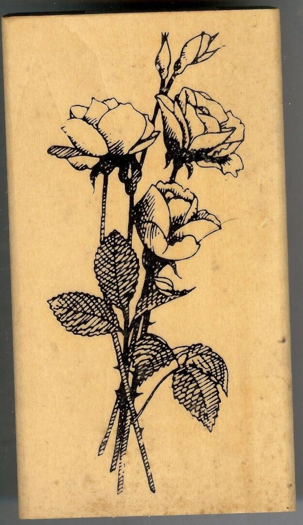 A picture of some flowers on a wooden block.