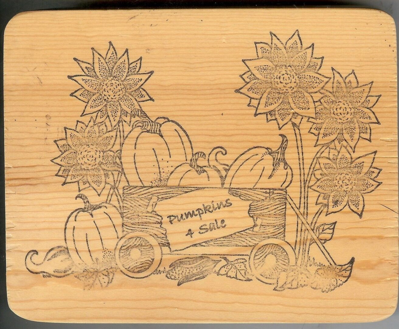 A wooden box with pumpkins and sunflowers on it.