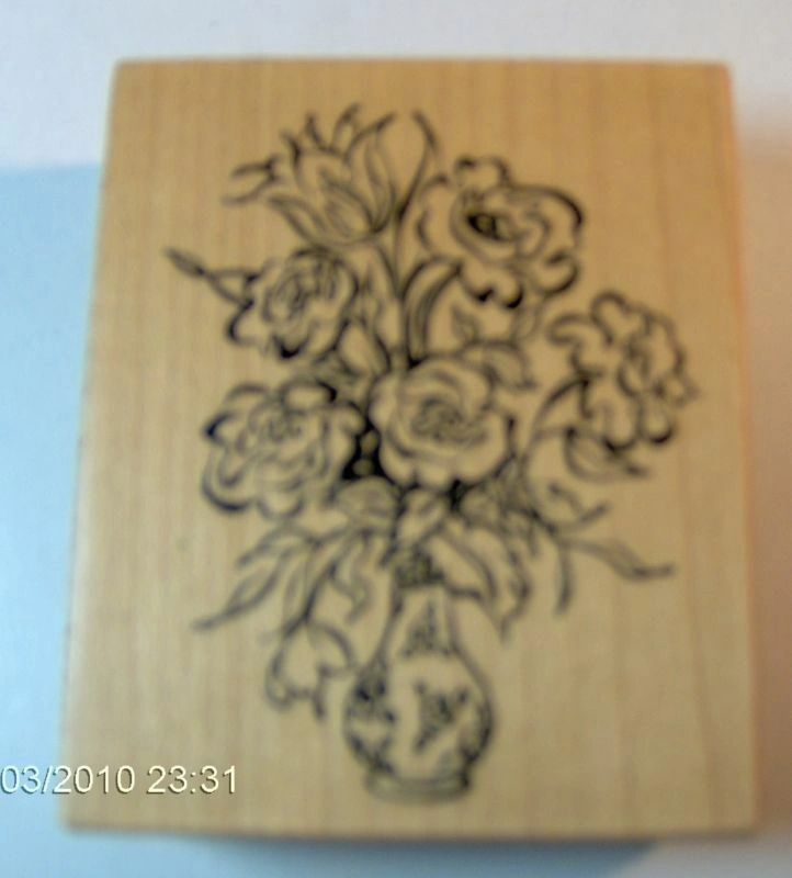 A vase of flowers is shown on this stamp.