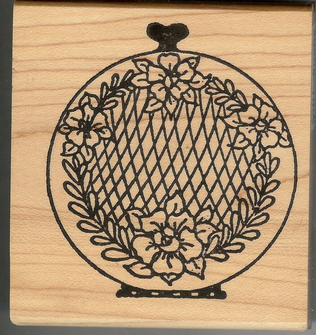 A wooden stamp with a floral design on it.
