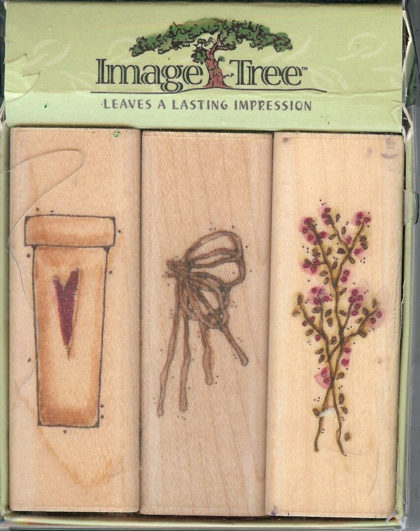 A set of three wooden bookmarks with flowers.