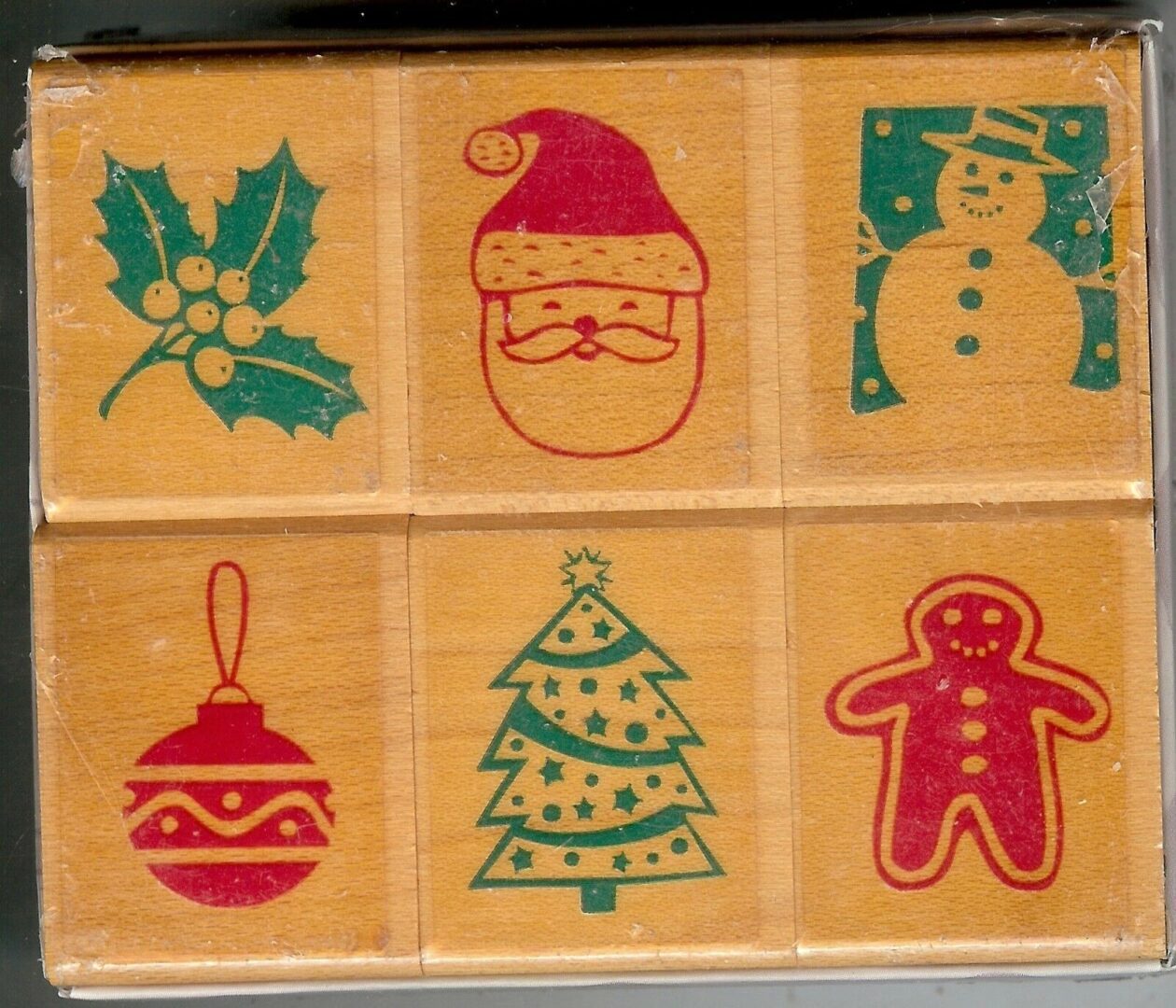 A wooden block with six different designs of christmas.