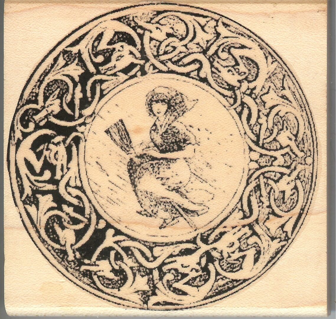 A picture of an old plate with a woman in the center.
