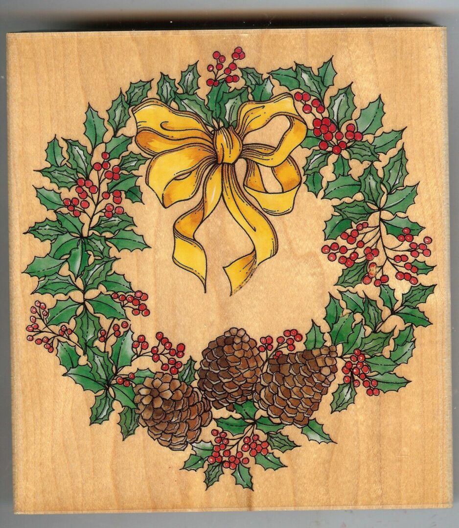 A wooden picture of a christmas wreath with berries and pine cones.