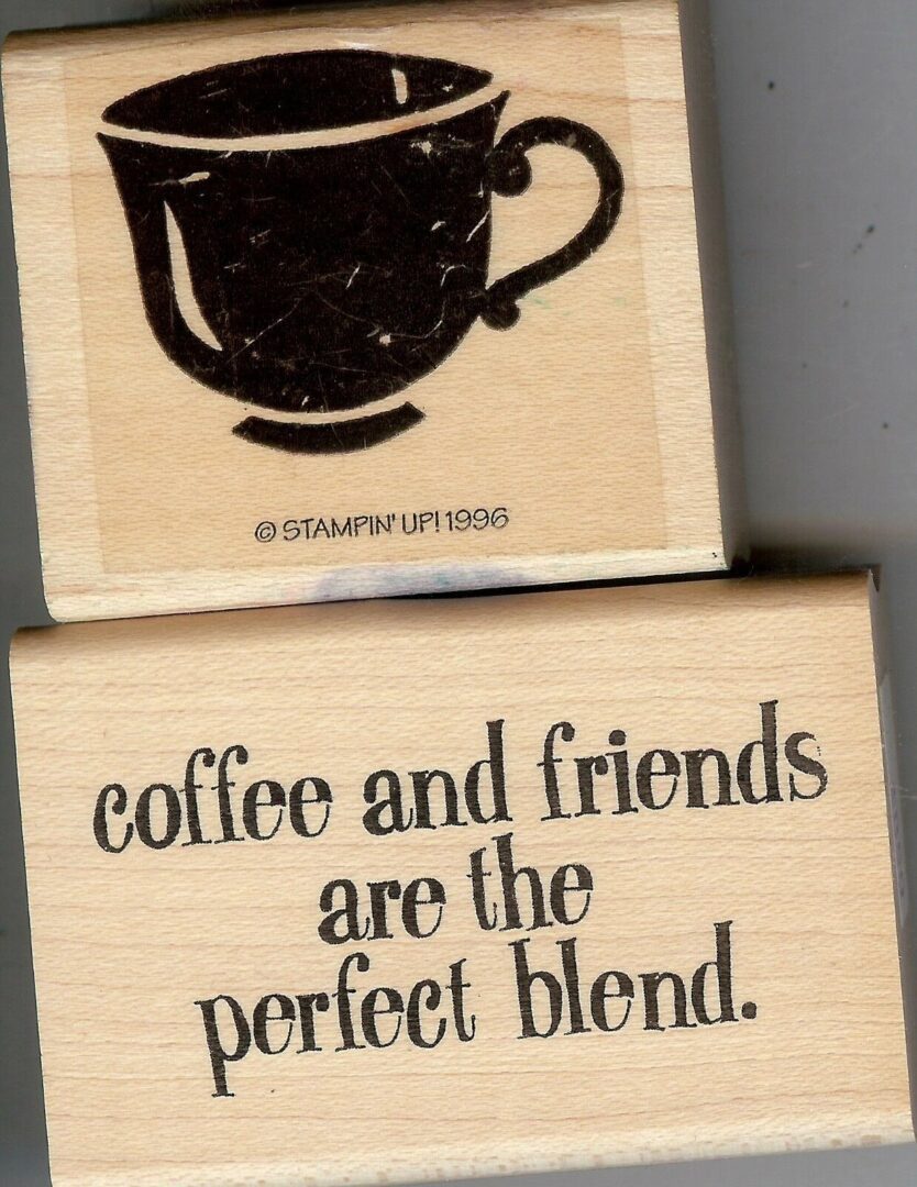 A couple of wooden blocks with some coffee related words.