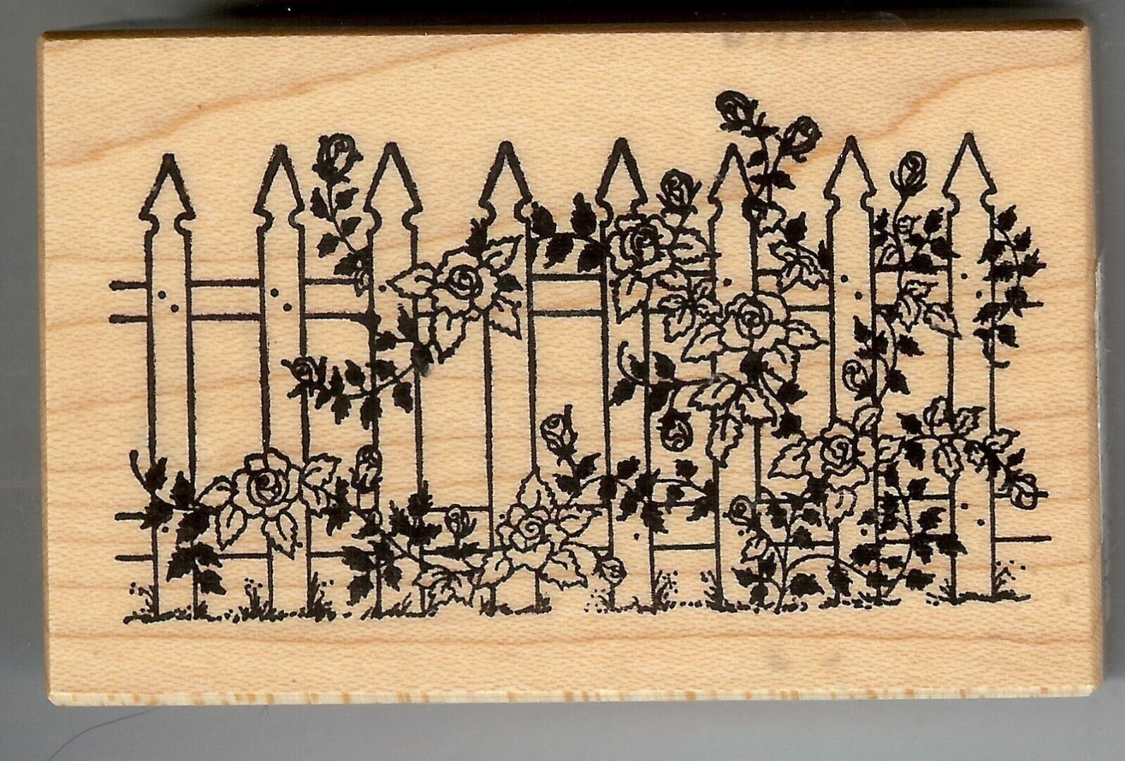 A fence with flowers and vines on it.