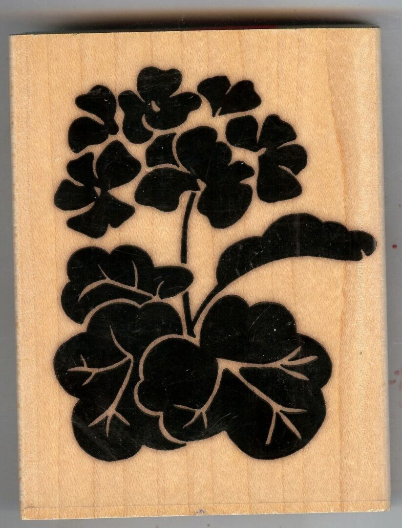 A picture of some flowers on a wooden block.