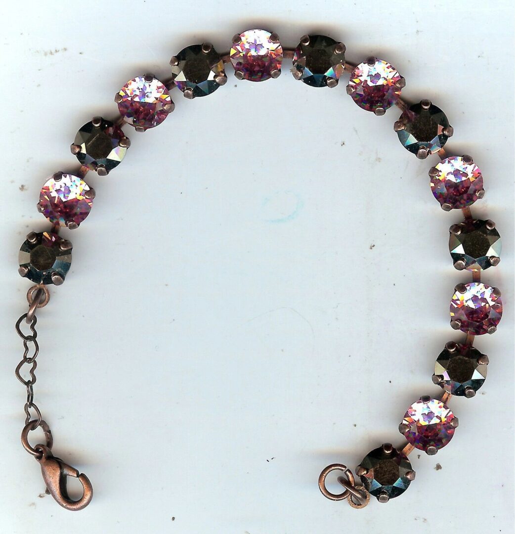 A bracelet with pink and black beads on it.