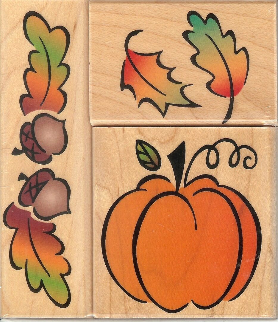 A set of four wooden stamps with leaves and pumpkins.