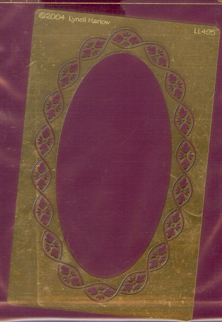 A purple and green oval frame on a piece of fabric.