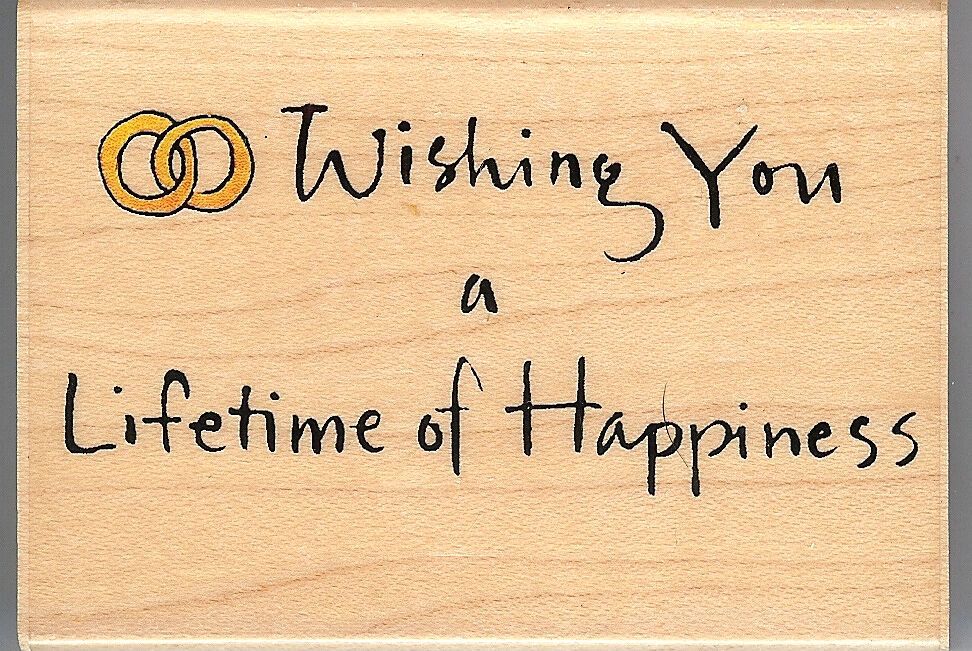 A wooden sign with the words " wishing you a lifetime of happiness ".