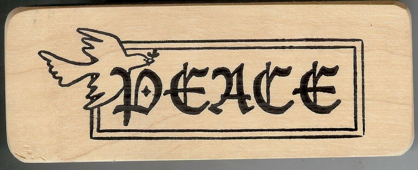 A wooden sign with the word peace written in it.