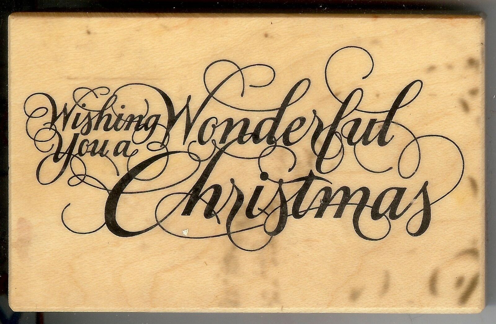 A wooden block with the words " wishing you a wonderful christmas ".