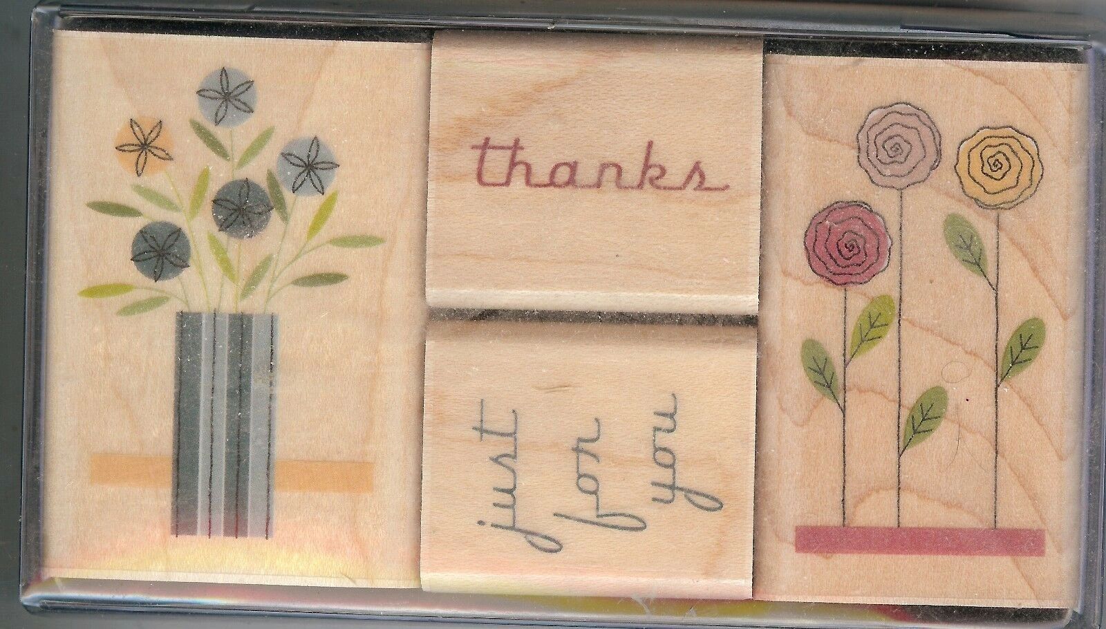 A set of four wooden blocks with words and flowers.