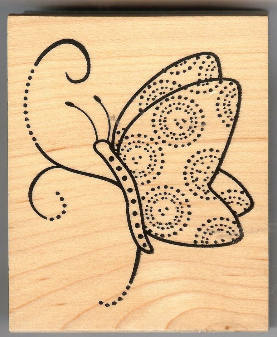 A butterfly with swirls and dots on it's wings.