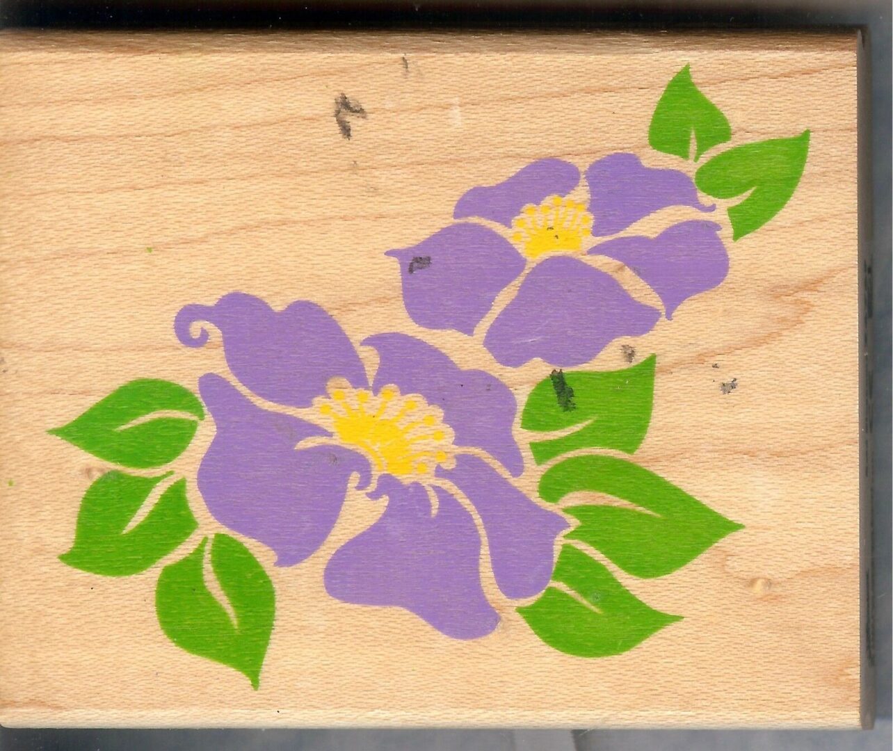 A wooden box with purple flowers on it.