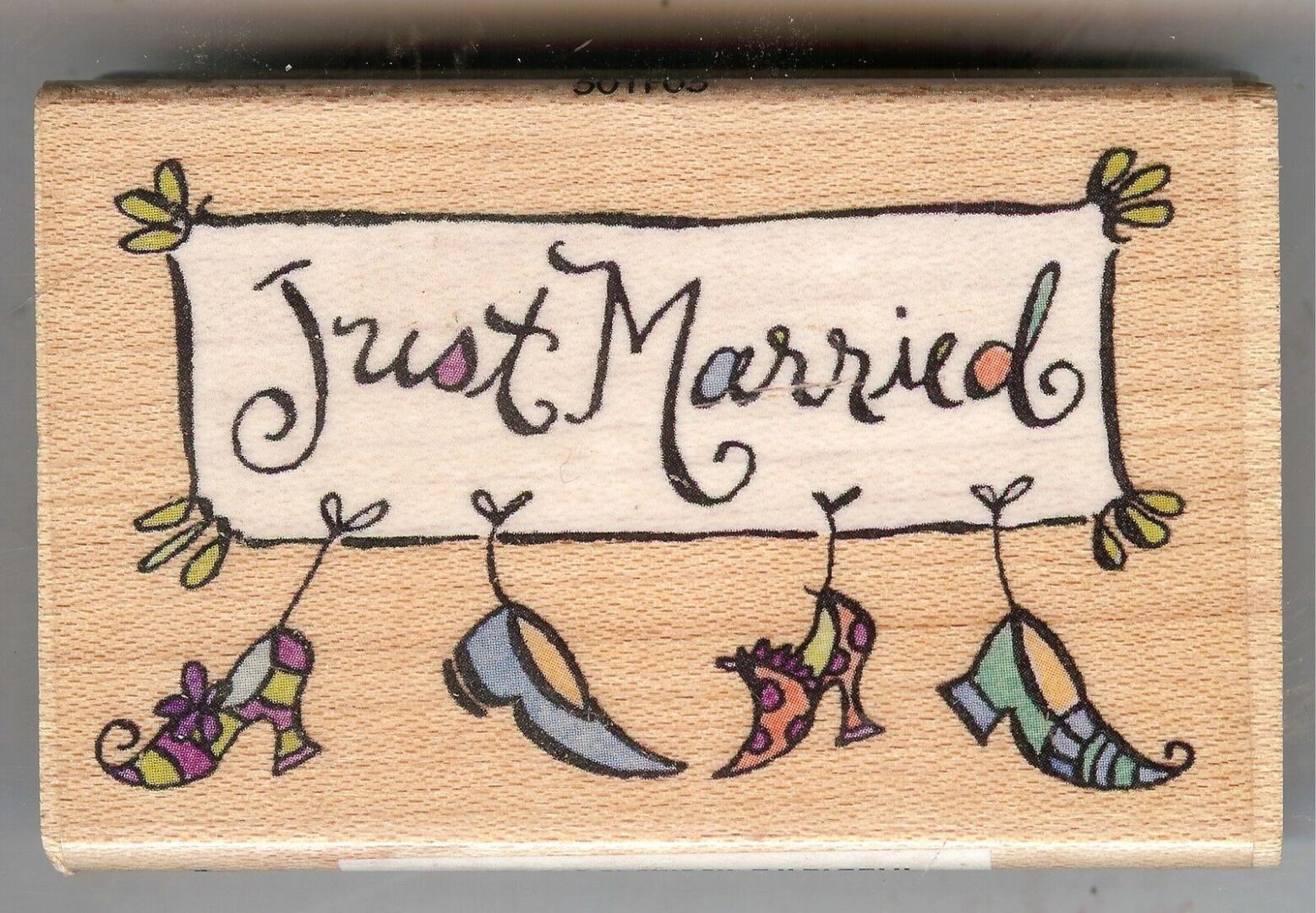 A wooden block with just married written on it