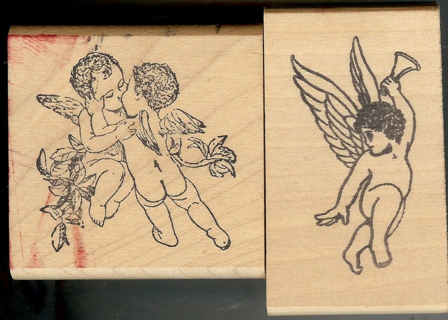 A couple of wooden stamps with angels on them