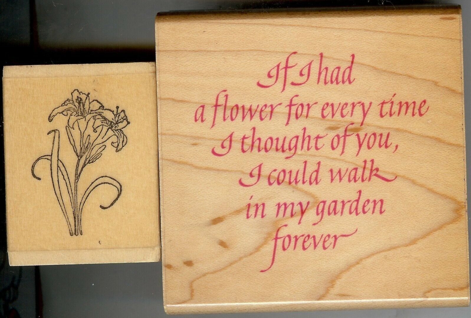 A flower is shown on the top of a wooden stamp.