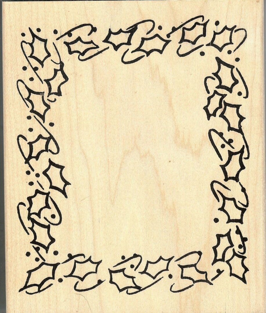 A wooden frame with holly leaves drawn on it.